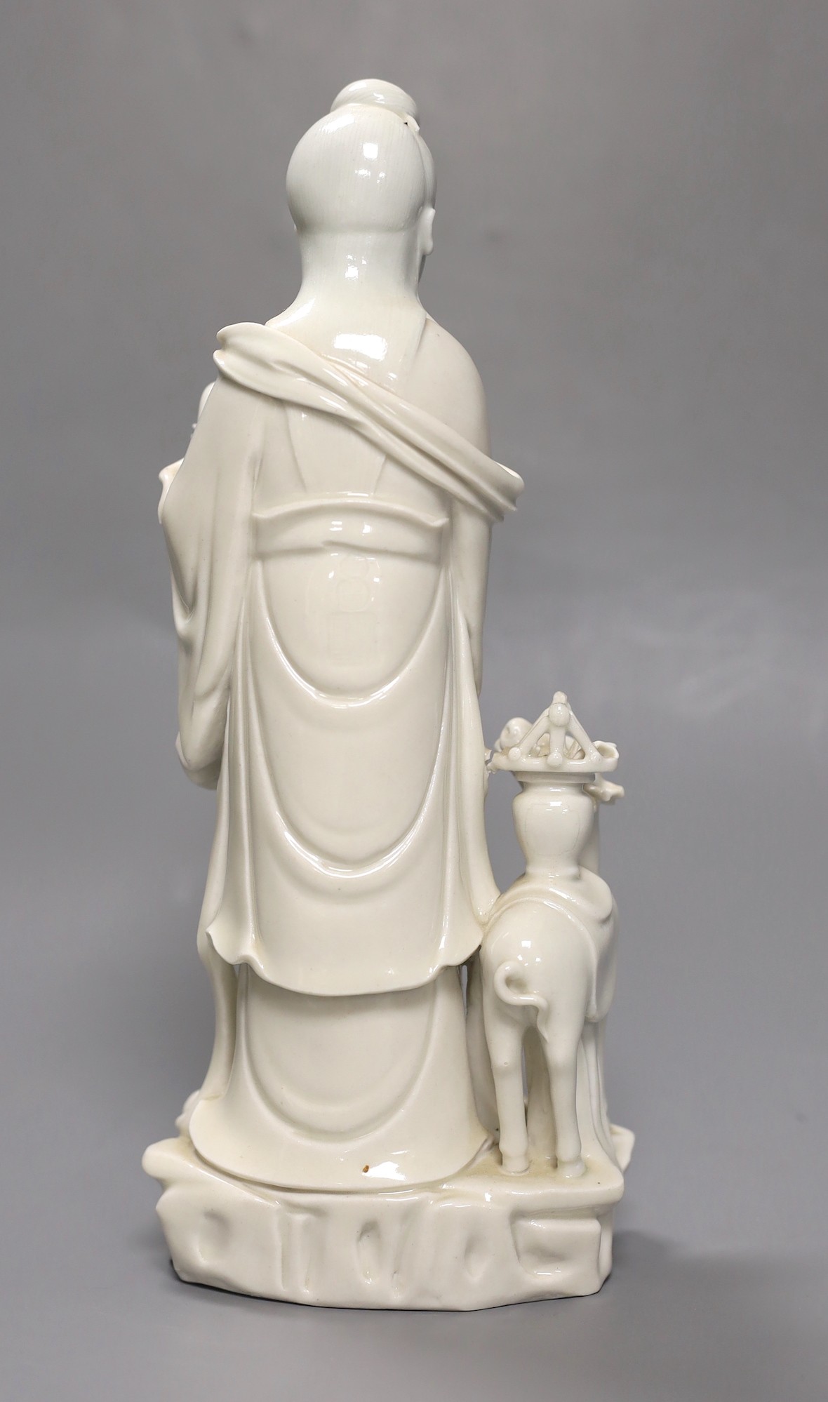 A Chinese Dehua blanc-de chine Guanyin group, late 19th/early 20th century, seal mark to back, 27cm